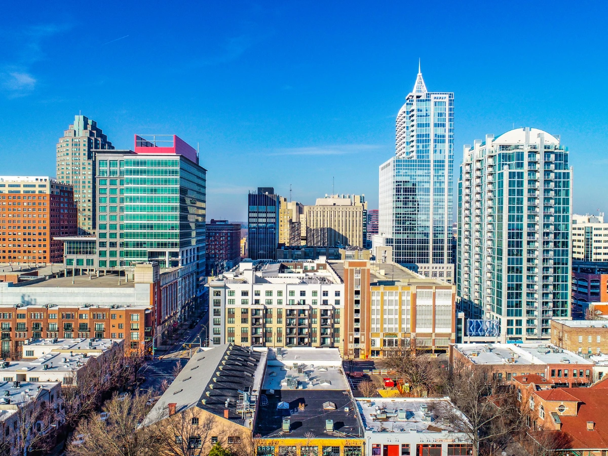 Modern downtown Raleigh cityscape illustrating the growth and development of North Carolina's capital from its founding in 1792 to a thriving metropolitan center today.