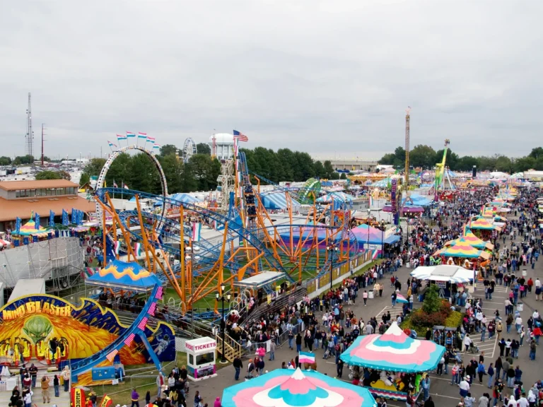 The North Carolina State Fair in Raleigh, NC, showcasing amusement rides, entertainment, agricultural exhibits, and thousands of attendees enjoying one of the state's largest annual events.