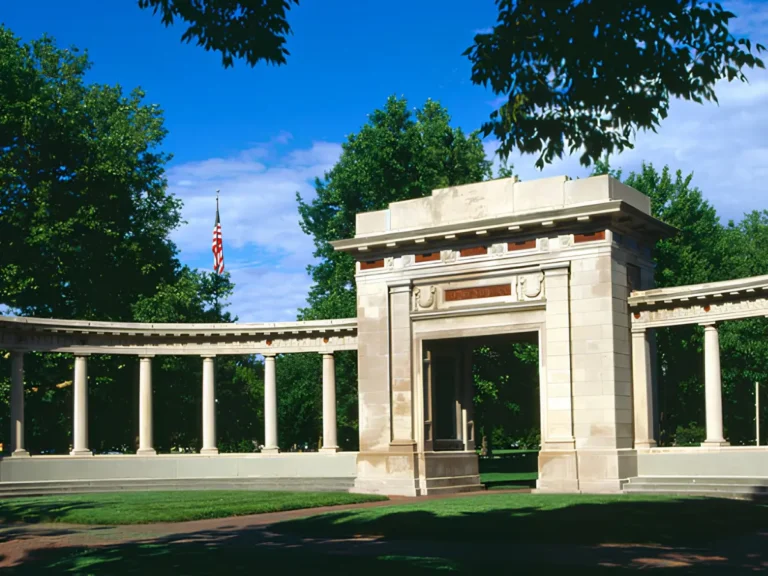 Historic memorial structure in Raleigh, NC, featuring a curved colonnade, stone architecture, and landscaped grounds reflecting the city's rich history and heritage.