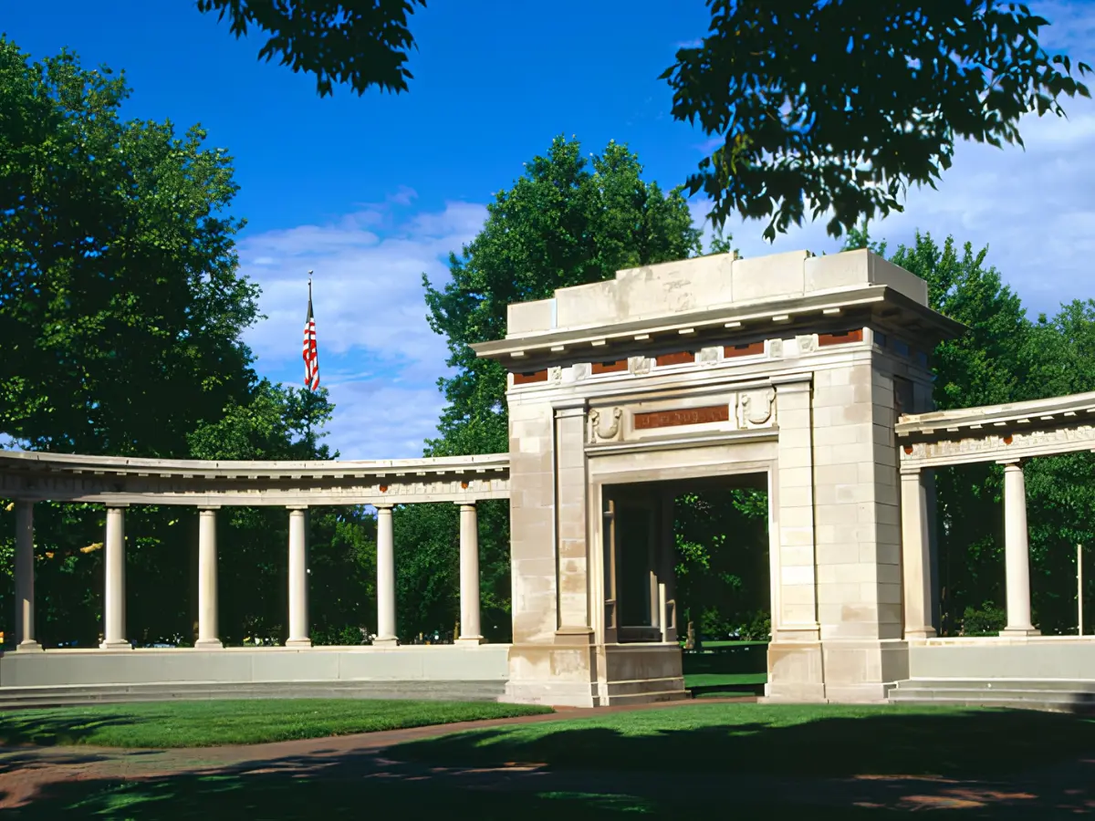 Historic memorial structure in Raleigh, NC, featuring a curved colonnade, stone architecture, and landscaped grounds reflecting the city's rich history and heritage.