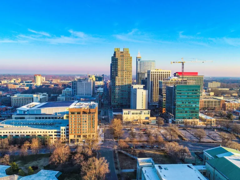 Downtown Raleigh skyline showcasing high-rise buildings, business districts, and economic development influenced by the growth of Research Triangle Park in North Carolina.