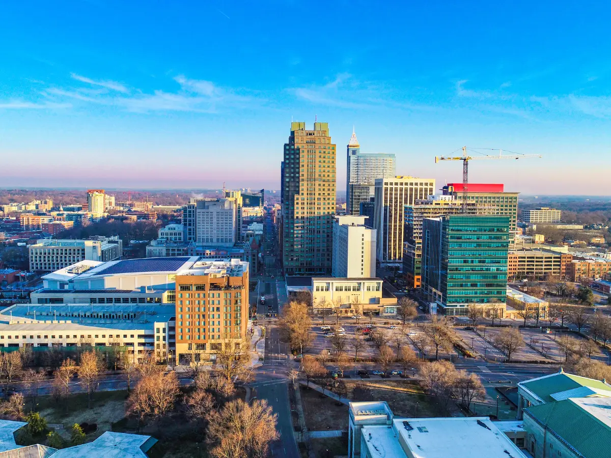 Downtown Raleigh skyline showcasing high-rise buildings, business districts, and economic development influenced by the growth of Research Triangle Park in North Carolina.
